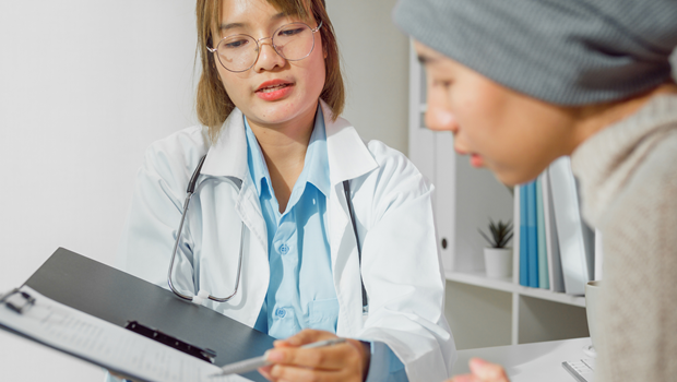 A young adult cancer patient meets with her doctor