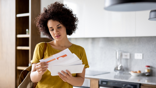 A woman opens her mail